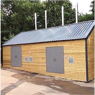 A wooden outbuilding with two grey steel security double doors on the front