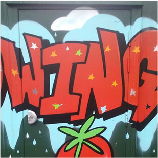 Green security door and the word swing graffitied over it in red and black with a blue outline and top of a carrot underneath